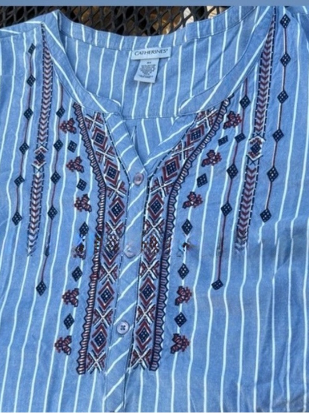 Catherine’s Blue and White Striped Denim Blouse with Red and White Embroidery